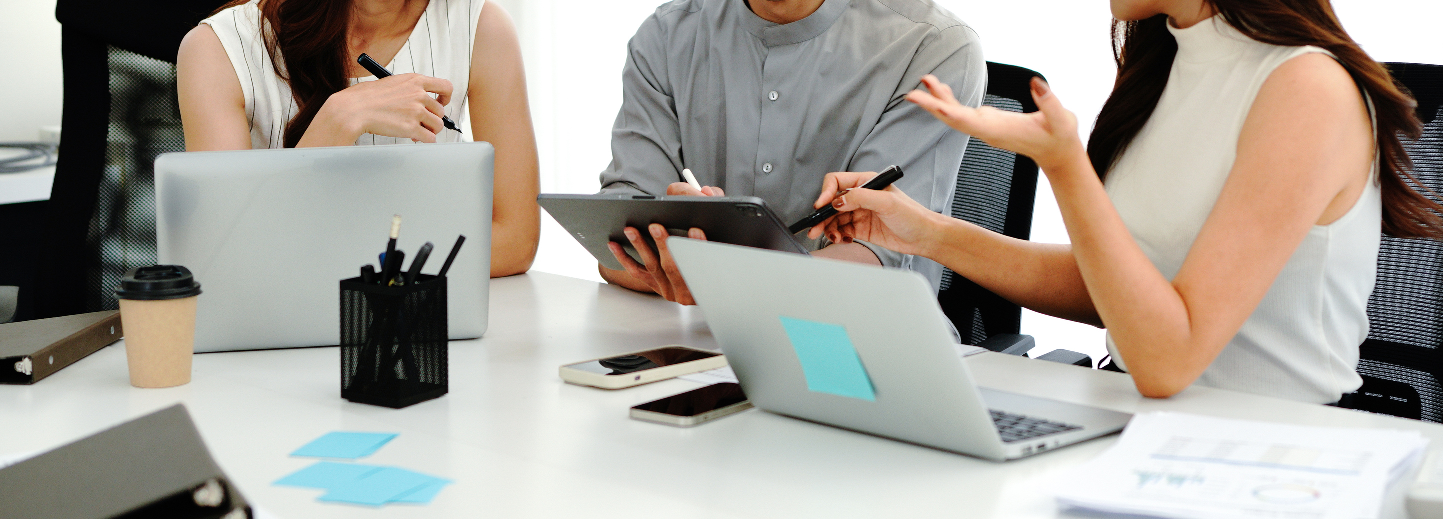 Close up shot business people team meeting in conference room in company. Businessman pointing pen at tablet on the table.