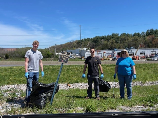 A group of people standing in grass

Description automatically generated