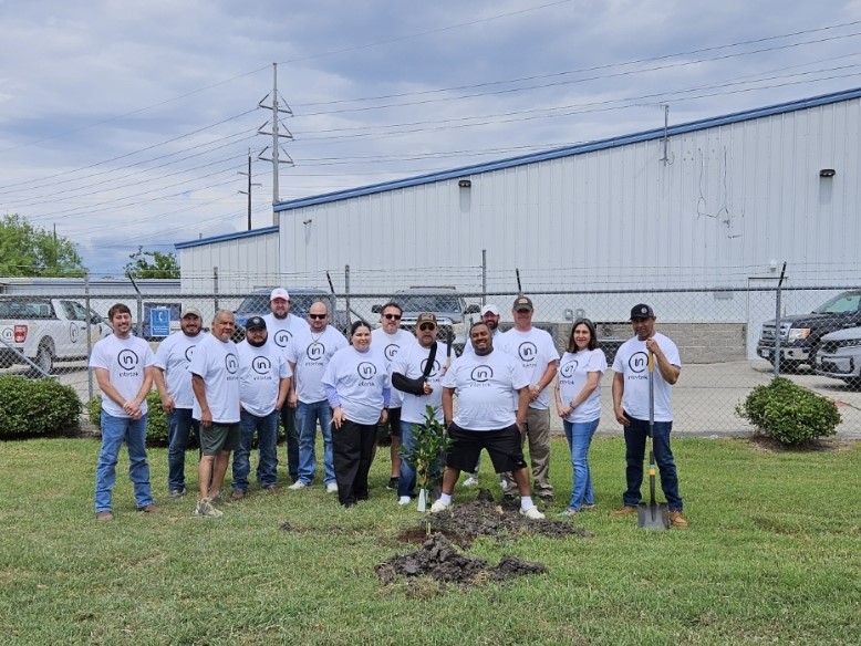 A group of people standing in a field

Description automatically generated