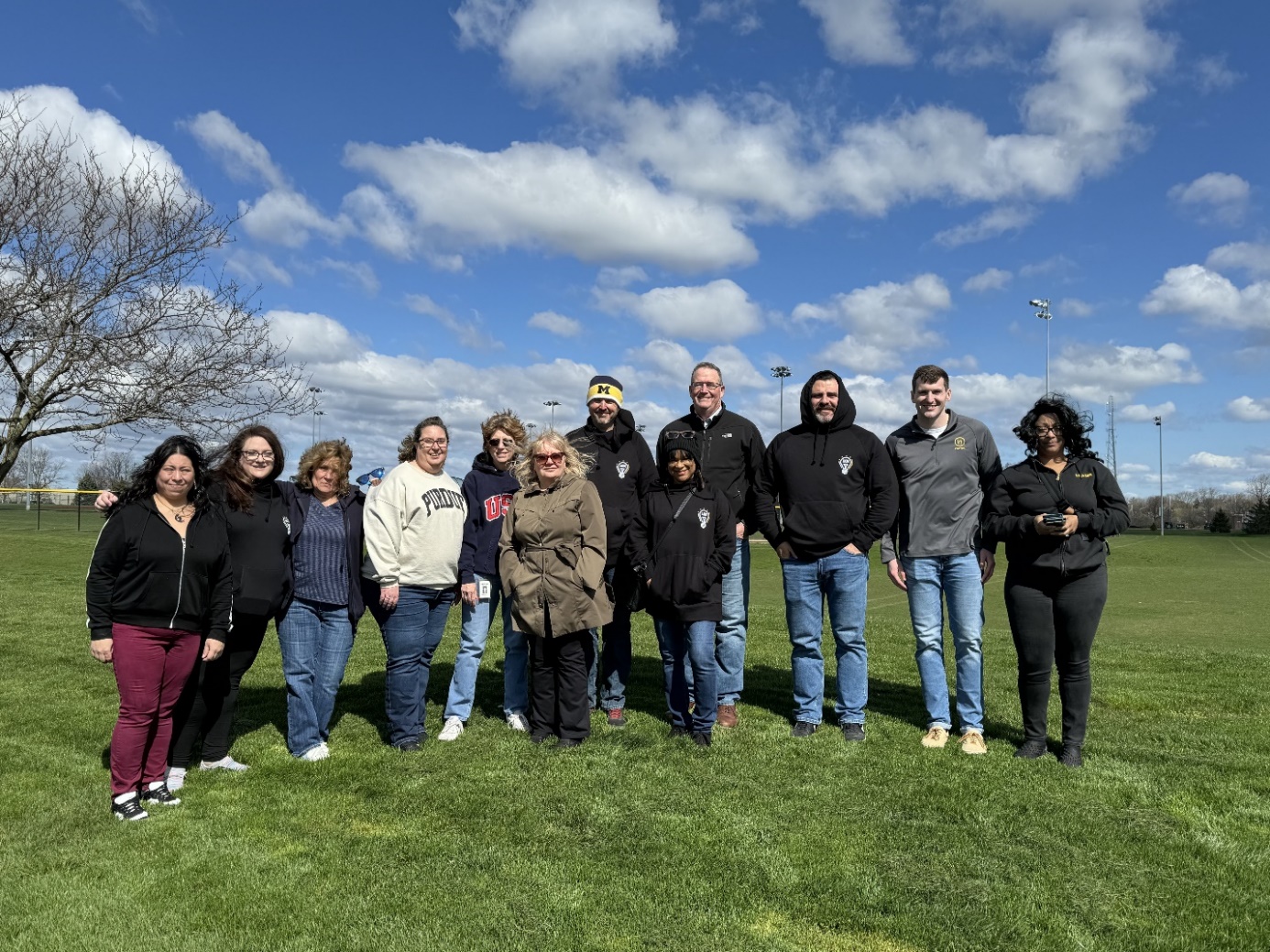 A group of people standing in a line

Description automatically generated