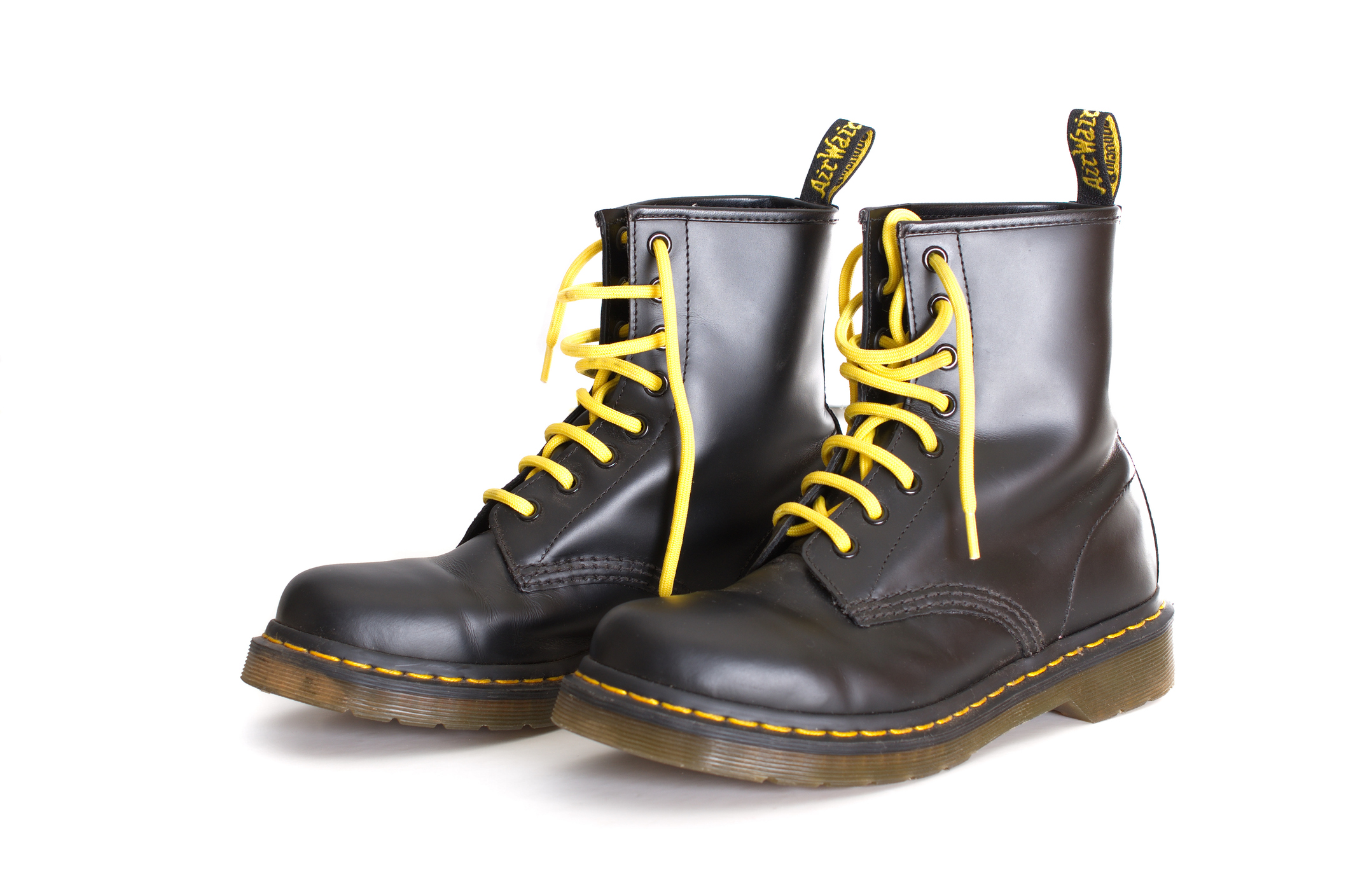 Tel Aviv, Israel - September 28, 2014: A pair of Doc Martens 8 eyelet 8 inch classic unisex black lace-up fashion combat boots with yellow laces and the sole visible