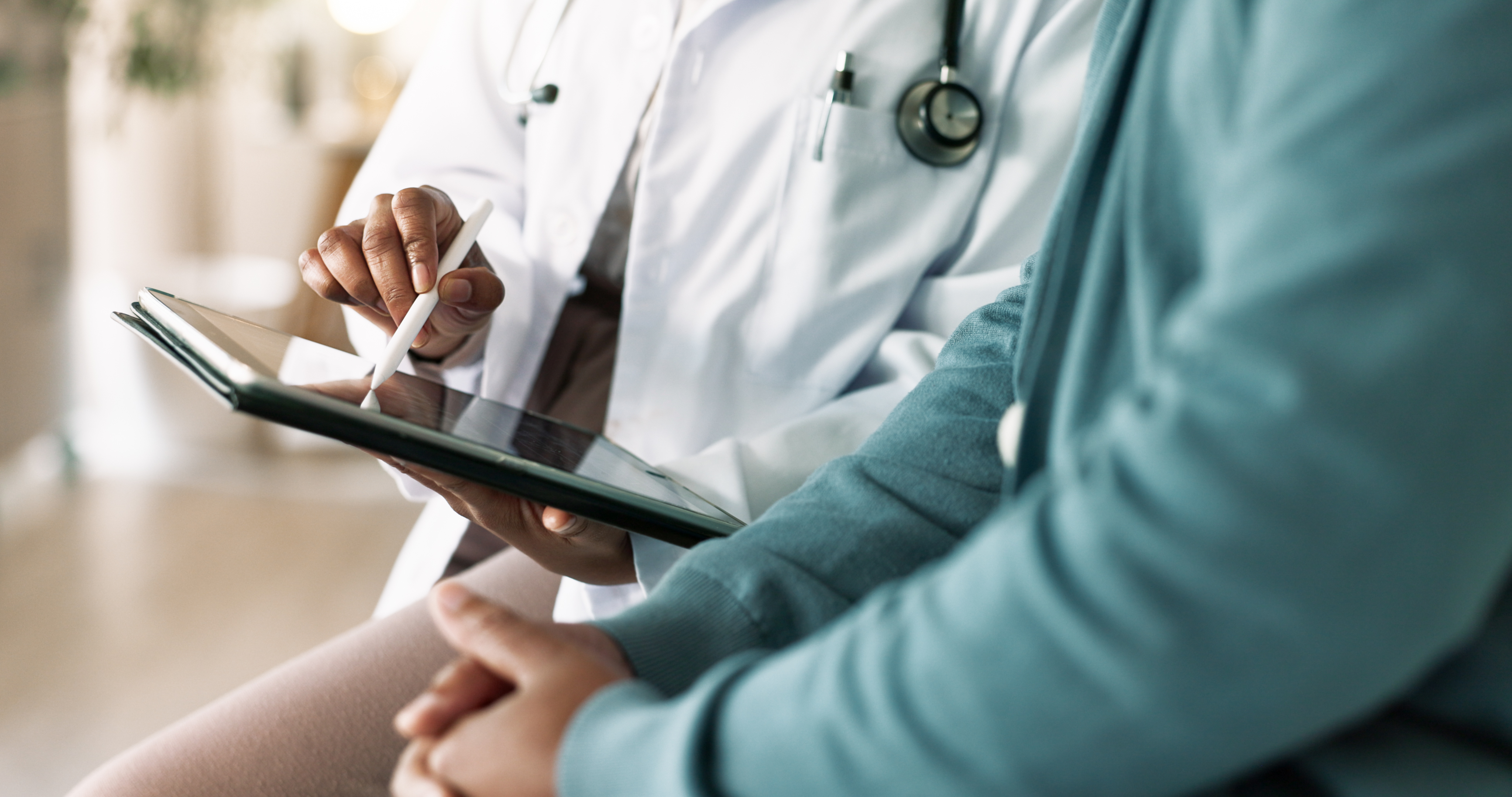 Doctor, hands and tablet with patient for consultation, medical advice or procedure at clinic. Closeup, healthcare employee and client with technology for health appointment or checklist at hospital