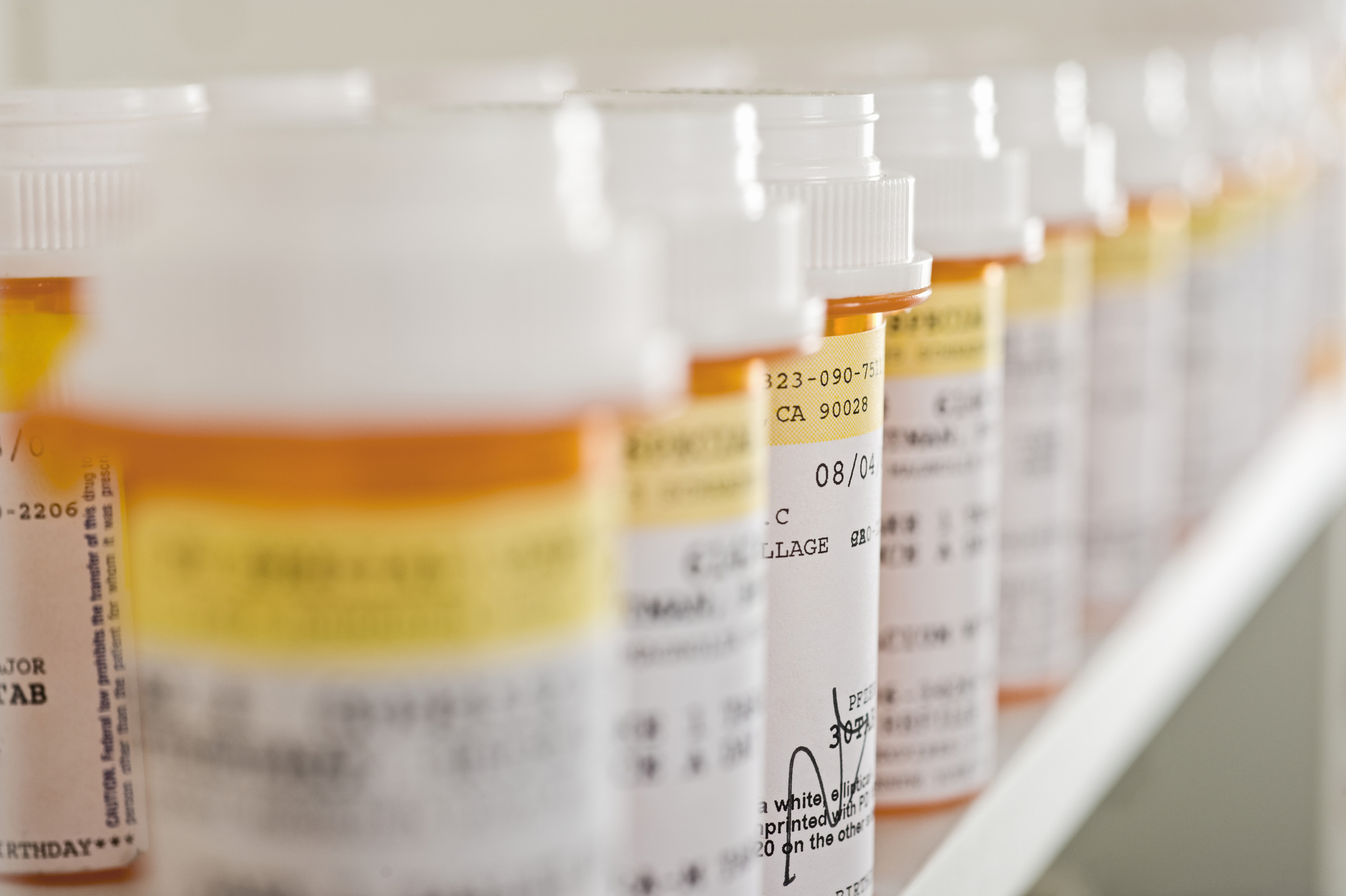 Bottles of pills arranged in shelf at a drugstore